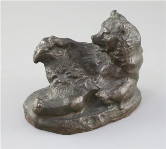 A Russian bronze figure of a reclining bear scratching its foot, 5in.